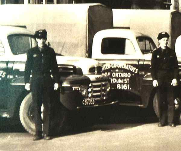 Two men in front of trucks