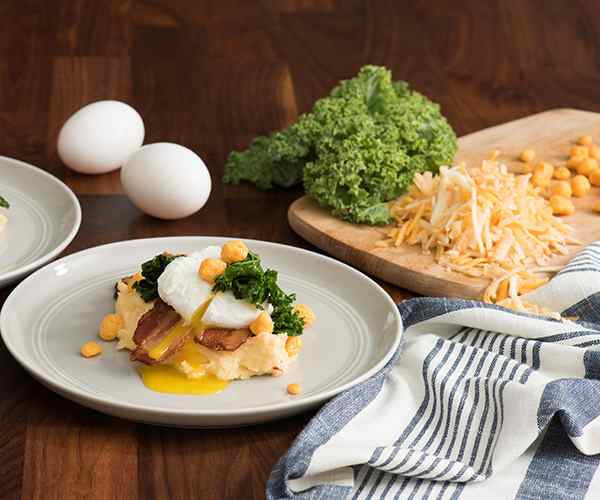 Photo of - Cheesy Grits with Poached Egg, Spicy Greens and Peppered Bacon